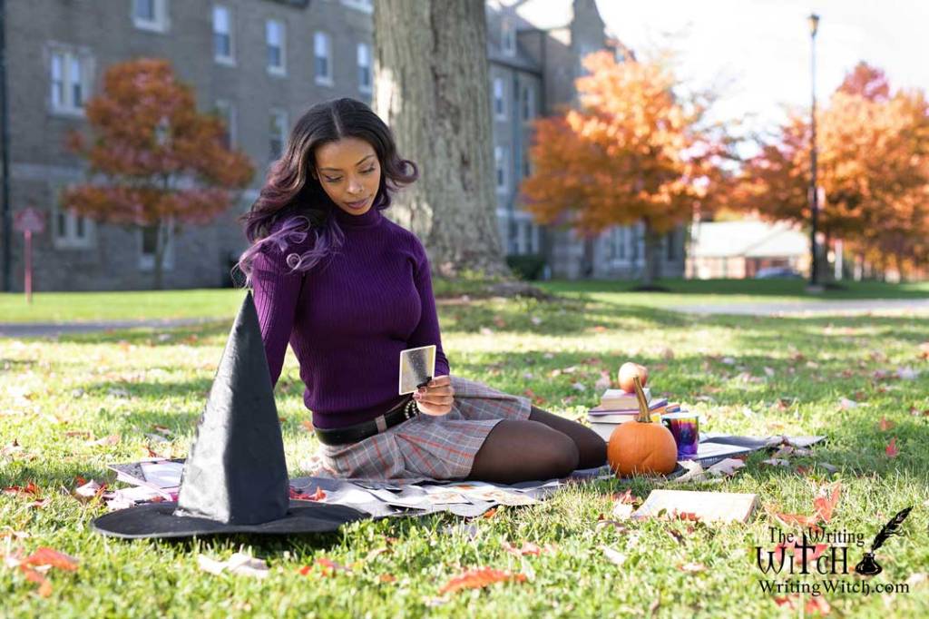 Afura reading tarot cards outdoors in autumn